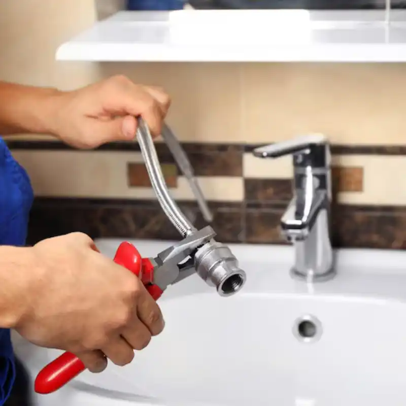 plumber-fixing-water-flexible-hose-bathroom